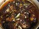 Ikan masak taucu pedas siap dimasak dalam pinggan – lauk kampung sedap dengan kuah taucu pekat dan ikan goreng garing.