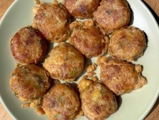 Begedil kentang goreng berwarna keemasan, rangup di luar dan lembut di dalam, dihidangkan panas dengan taburan daun sup