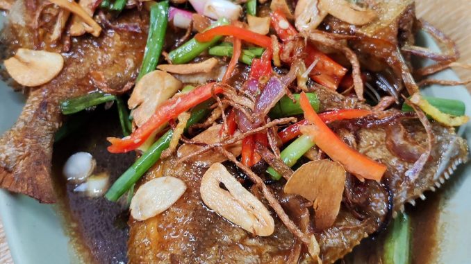 Ikan bawal digoreng garing sebelum disiram sos kicap Chinese style.